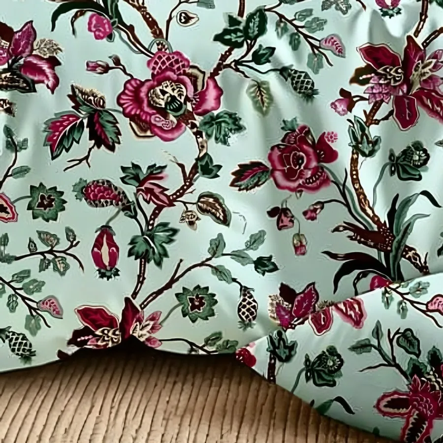 Close-up of the rose trellis print in Rose pink on aqua (DH-08)
