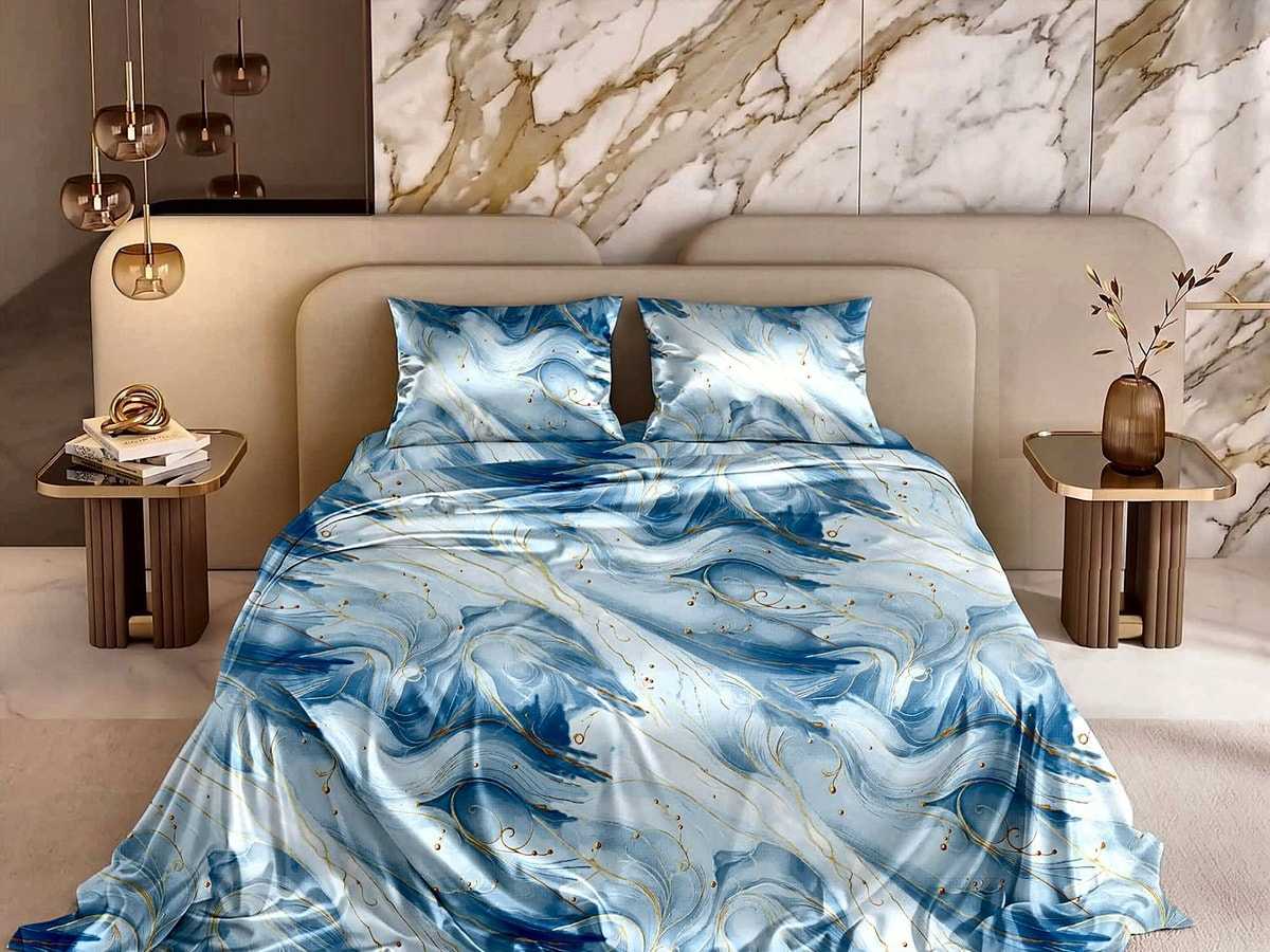 A bed made with the Marble veining glace cotton set in blue and gold