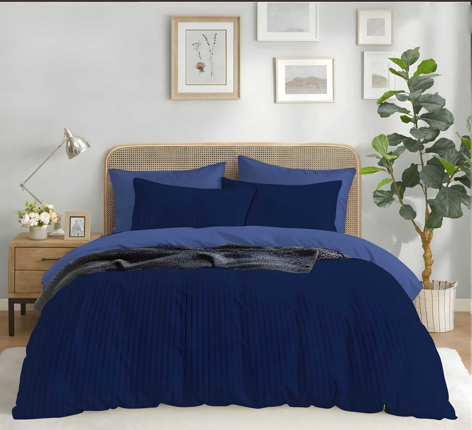 A hotel bed made with the navy satin stripe bedsheet