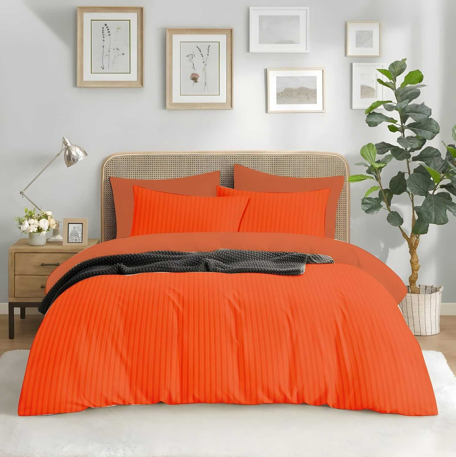 Satin stripe bedsheet set in Bhagwa (ST-17) on a made bed in a bright bedroom